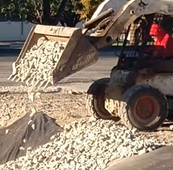 Skid Loader Dumping Rip Rap